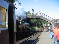 Steaming under the footbridge