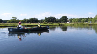 Tranquil boating shot with windmill